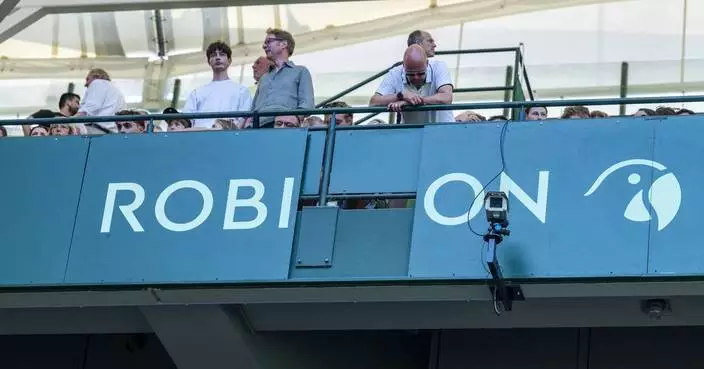 Zverev steps in after an advertising board lands on a spectator at Halle